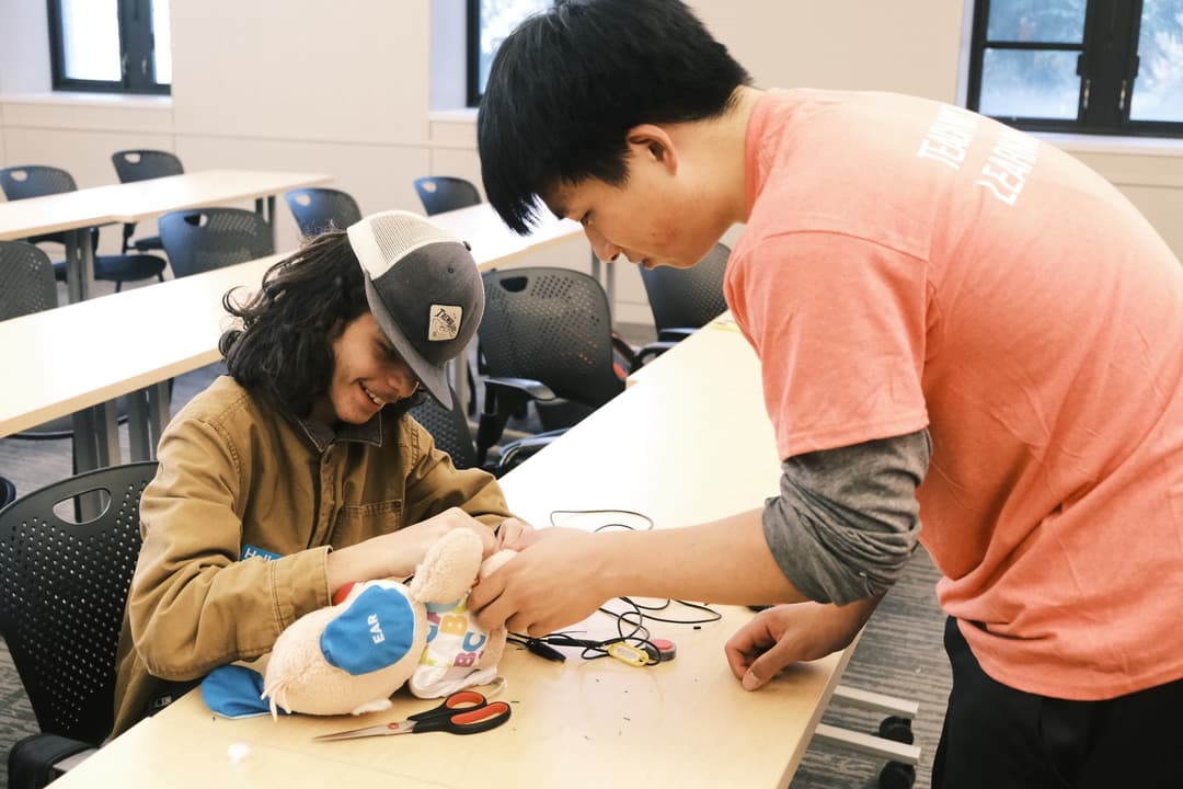 Cornell Assistive Technologies team member helping a student